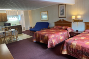 motel suite with beds and kitchen