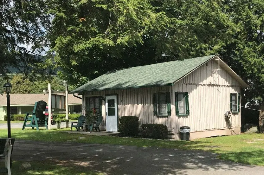 Cabin exterior with 2 Adirondack chairs out front